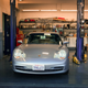 A silver 996 911 waits to go onto a car hoist for its pre-purchase inspection.